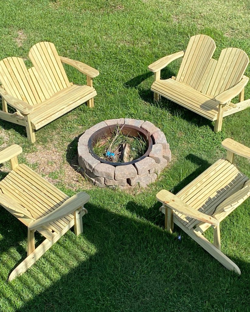 four double adirondack chairs at fire pit